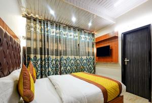 a bedroom with a bed and a television in it at Hotel Preet - Family Hotel in New Delhi