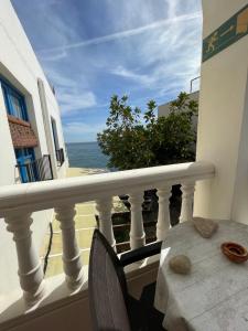 a balcony with a table and a view of the ocean at EL DUENDE in Las Negras