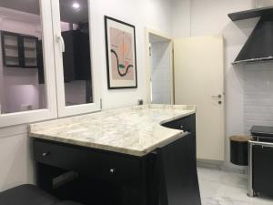 a kitchen with a marble counter top and a sink at Studio Apartment Santa Caterina in Bologna