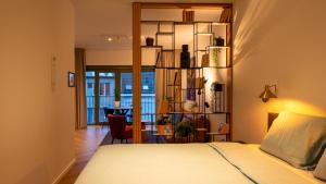 a bedroom with a bed and a dining room at Pacific Residences - Studio in Antwerp