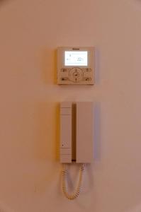 a phone hanging on a wall with a cord at Pacific Residences - Studio in Antwerp