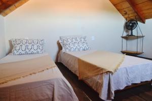a bedroom with two beds at Chalés Cabocla da Lua in Caraíva