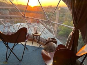 a room with chairs and a table and a window at Sunset Dome - Outdoor Shower/Composting Toilet in Valley Center