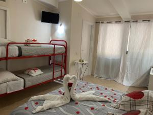 a bedroom with two bunk beds with hearts on the floor at B&B La Penisola in Gragnano