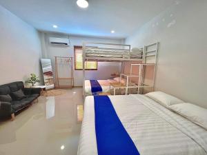 a bedroom with two bunk beds and a couch at GK Pool Villa in Ban Thap Tai (1)