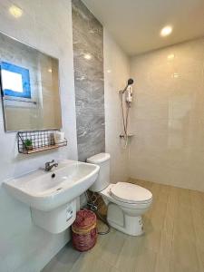 a white bathroom with a sink and a toilet at GK Pool Villa in Ban Thap Tai (1)