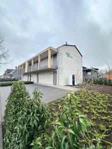een gebouw met veel planten ervoor bij City-Apparte Boarding -Einzel-Studios- Grenznähe NL in Gronau