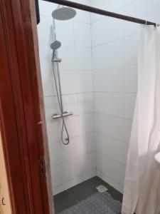 a shower in a bathroom with a shower curtain at AJALA Lodge in Badagry +30 photos