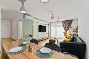 a living room with a dining table and a couch at B-Holiday Luxury Apartments in Braşov