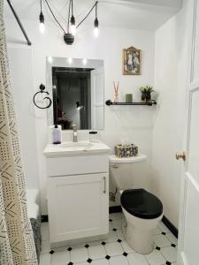 a bathroom with a white sink and a toilet at Cozy 1BR Near Convention Center Downtown in Seattle