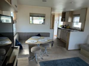a small kitchen and a small table in a caravan at The Lay By in Prestonpans