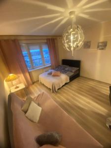a bedroom with a bed and a chandelier at Studio Gdańsk Śródmieście in Gdańsk