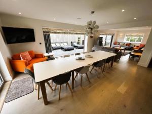 a dining room and living room with a table and chairs at Laurel Cottage in Sandown