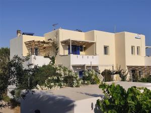 a large white building with trees in front of it at Actis studios 2 in Stelida