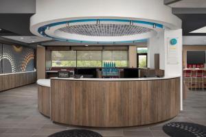 a large lobby with a reception desk in a building at Tru By Hilton San Antonio North in San Antonio