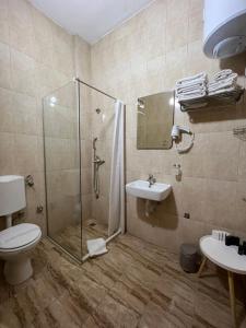 a bathroom with a shower and a toilet and a sink at Stan na dan / rent-a-flat per day in Bugojno