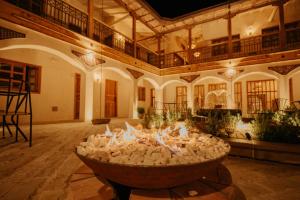 a large room with a fire pit in the middle of a building at Hotel La Corada in Villa de Leyva