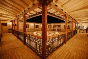 an inside view of a porch with a wooden deck at Hotel La Corada in Villa de Leyva