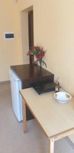 a room with a desk and a table with a computer at Simple family apartment in Liepāja