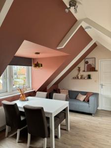 a living room with a table and a couch at `t Fabriekje in Buren