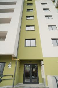 a building with a door in the middle of two buildings at Green Studio in Tîrgu Neamţ