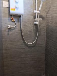 a shower with a hose attached to a wall at Palms Haven - Mauritius - Modern and luxury vacation home in Phoenix