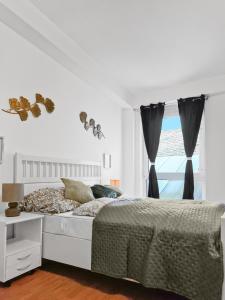 Habitación blanca con cama y ventana en sparkasse platz 8, en Stockerau