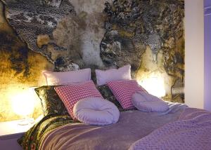 a bedroom with a bed with pillows and a wall at Lago Iseo View in Zone