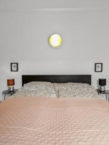 a bedroom with a bed with a light on the wall at sparkasse platz 8 in Stockerau