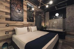 a bedroom with a king sized bed and a bathroom at Hotel Lleras Medellin in Medellín