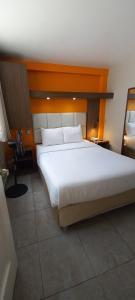 Cama ou camas em um quarto em Hotel Residencial Alfa