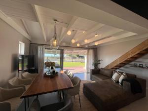 a living room with a couch and a table at Beachfront Kite House No 1 Shaapenzicht 1 in Langebaan