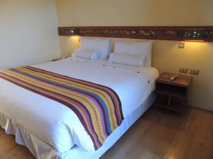 Postel nebo postele na pokoji v ubytování Taypikala Hotel Cusco