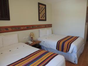 Postel nebo postele na pokoji v ubytování Taypikala Hotel Cusco
