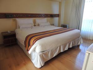 Postel nebo postele na pokoji v ubytování Taypikala Hotel Cusco