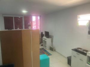 a living room with a cabinet and a television at Vidigal Sol in Rio de Janeiro