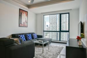 a living room with a couch and a table at Casa Residency Service Apartment By Moonlight in Kuala Lumpur