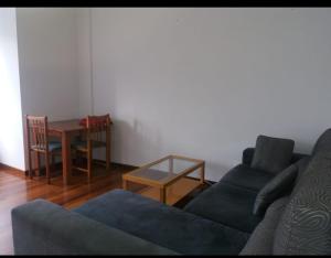 a living room with a couch and a table at PISO DEL PARQUE 2 in Santiago de Compostela