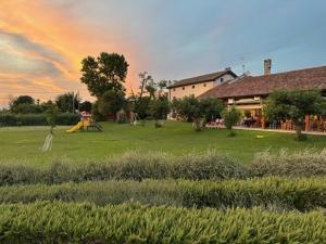 a park with a playground with a slide and a house at Agrimargherita in Caorle