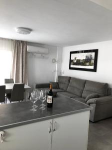 a living room with a couch and two wine glasses at Casa de Feliz in Calpe
