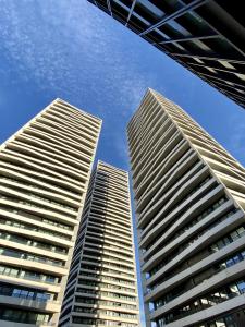three tall buildings against a blue sky at GLAD Spot: Zurich - Central - Design - Netflix in Zurich