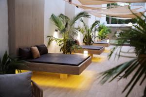 a living room with a couch and some plants at BLU Apartments in Bamako