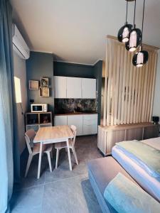a bedroom with a table and a bed at Suite Ducco ospedale civile in Brescia