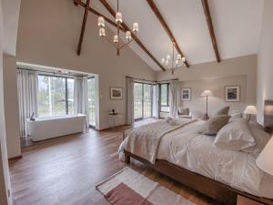 a bedroom with a large bed and a bath tub at Sierra Sacred Valley in Urubamba