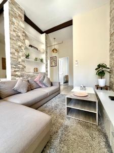 a living room with a couch and a table at Le Théâtro in Orange