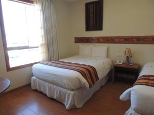 Postel nebo postele na pokoji v ubytování Taypikala Hotel Cusco