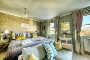 a bedroom with a bed and a couch and a mirror at Hill House in Bath