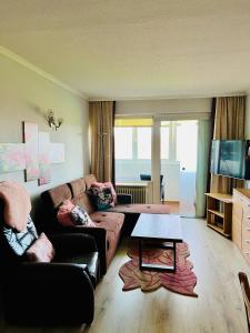 a living room with a couch and a table at Ferienwohnung 258 Haus Schleswig in Kalifornien