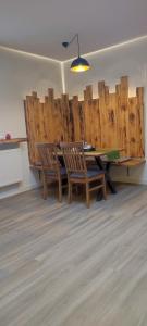 a dining room with a table and chairs and wooden walls at Hotel Aits garni in Nordenham