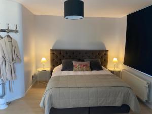 a bedroom with a large bed and a large tv at B&B Aline Florentine in Kortenberg